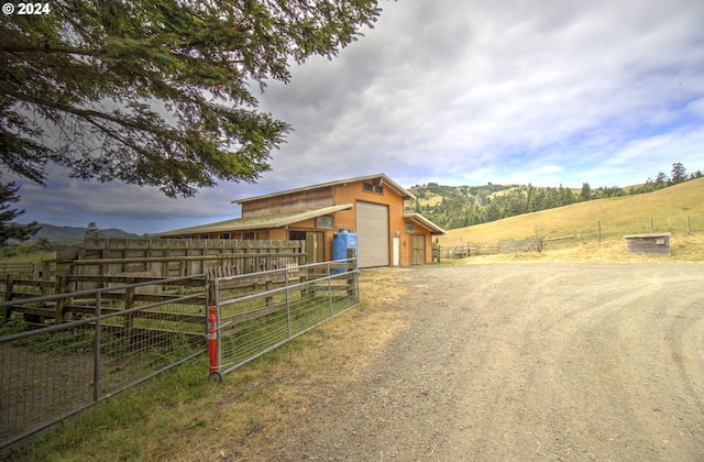 view of stable with a rural view