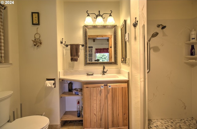 bathroom featuring vanity, toilet, and walk in shower