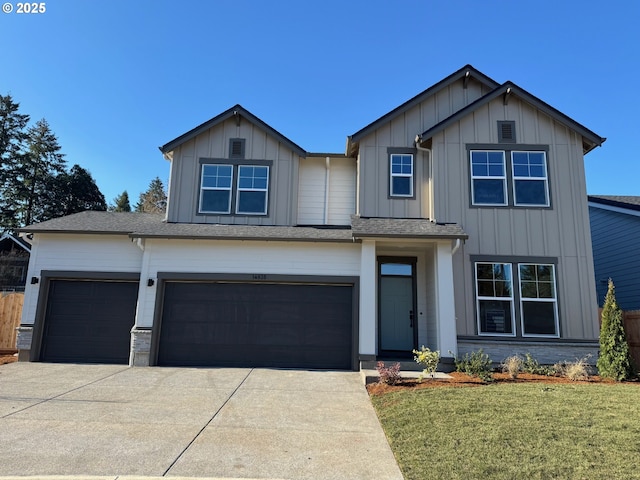 view of front of house with a garage and a front yard