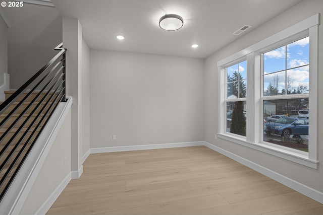 spare room featuring light hardwood / wood-style floors