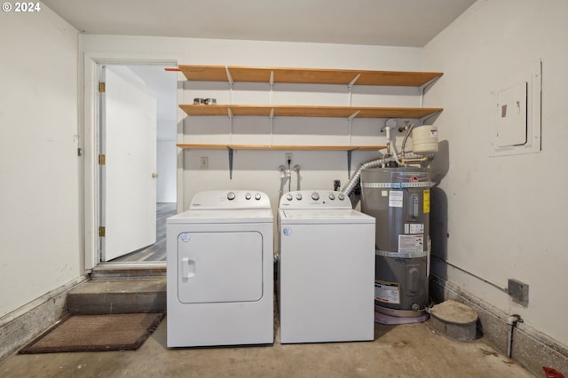 washroom featuring secured water heater, independent washer and dryer, and electric panel