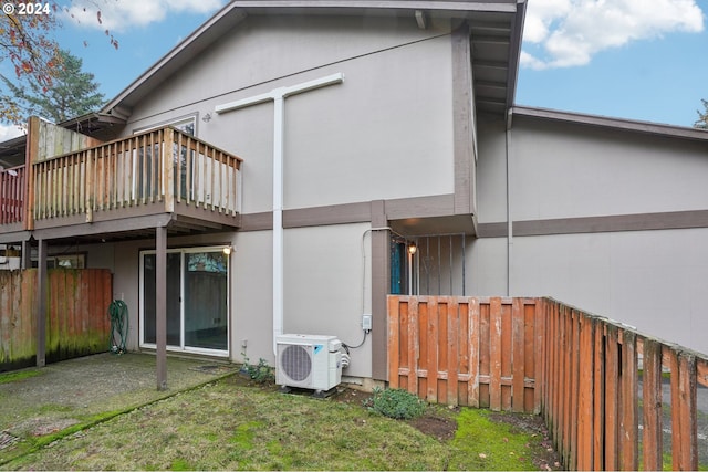 rear view of property featuring ac unit