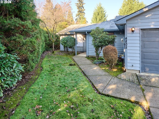 exterior space with a lawn and a garage