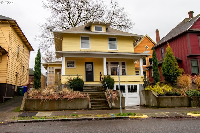 view of front of property with a porch and a garage