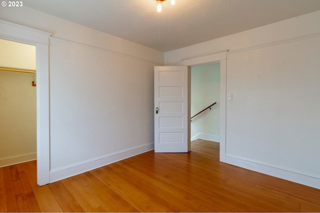 empty room with hardwood / wood-style flooring