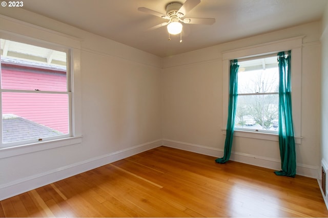 unfurnished room with wood-type flooring and ceiling fan