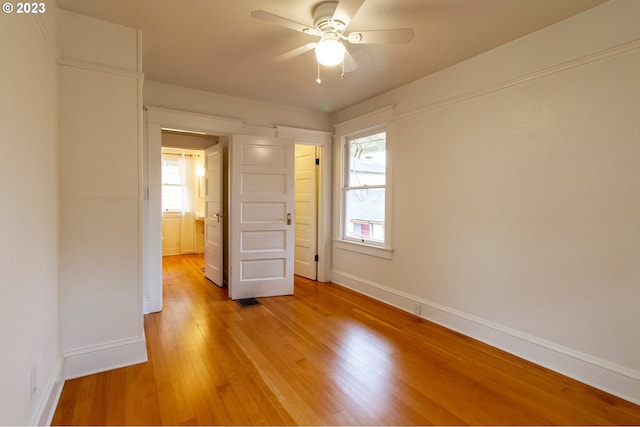 unfurnished bedroom featuring hardwood / wood-style floors and ceiling fan