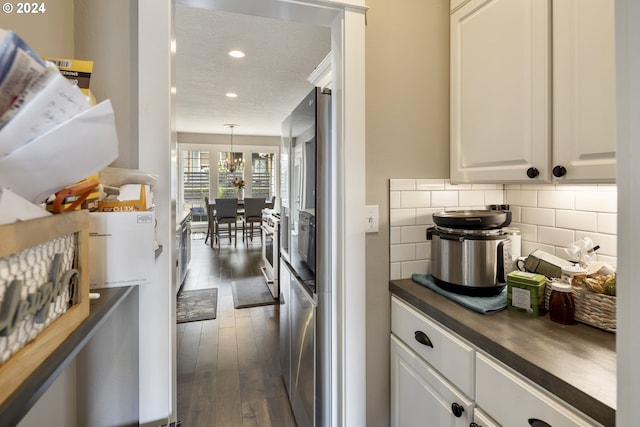 kitchen featuring white cabinets, dark hardwood / wood-style flooring, and tasteful backsplash