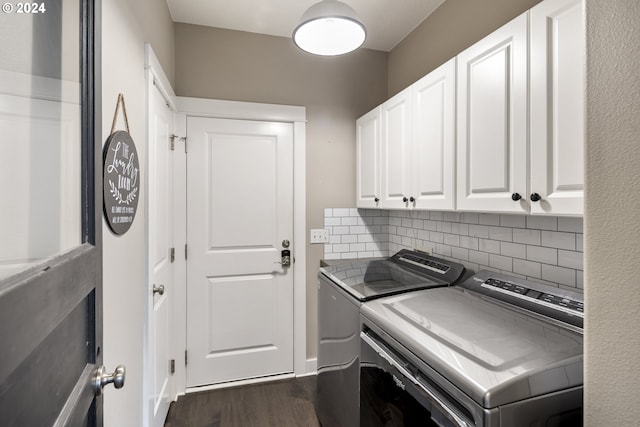 washroom featuring cabinets, dark hardwood / wood-style floors, and washer and dryer