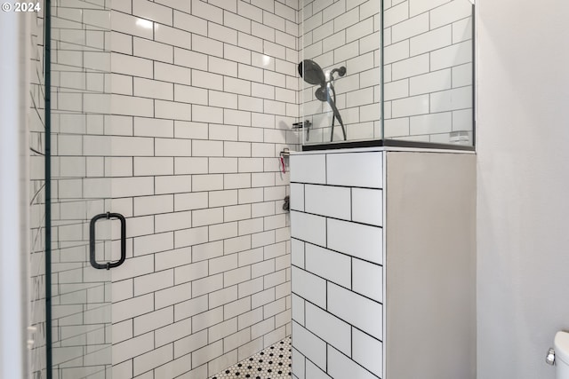 bathroom featuring walk in shower and toilet