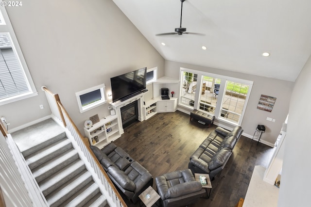 living room with ceiling fan, high vaulted ceiling, and dark hardwood / wood-style floors