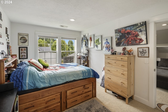 carpeted bedroom with a textured ceiling