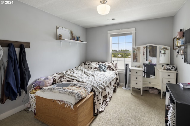 carpeted bedroom featuring a textured ceiling