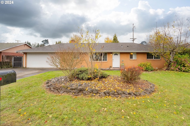 single story home featuring a garage and a front yard