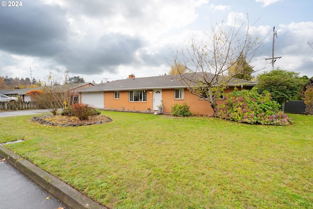 ranch-style home with a garage and a front lawn