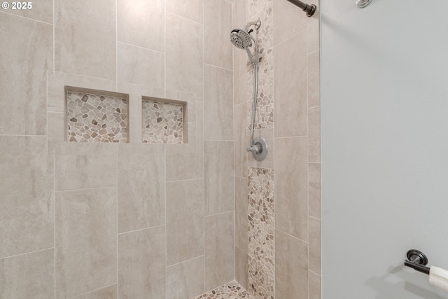 bathroom with a tile shower