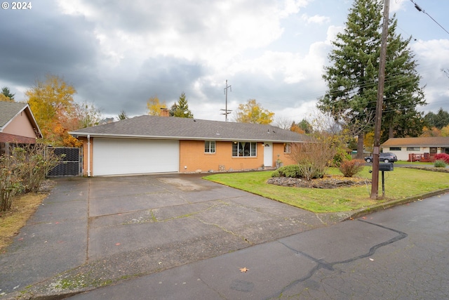 ranch-style home with a garage and a front yard