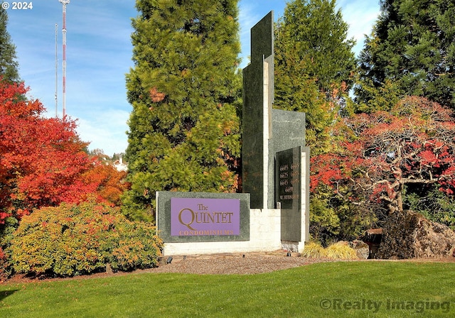 community / neighborhood sign with a yard