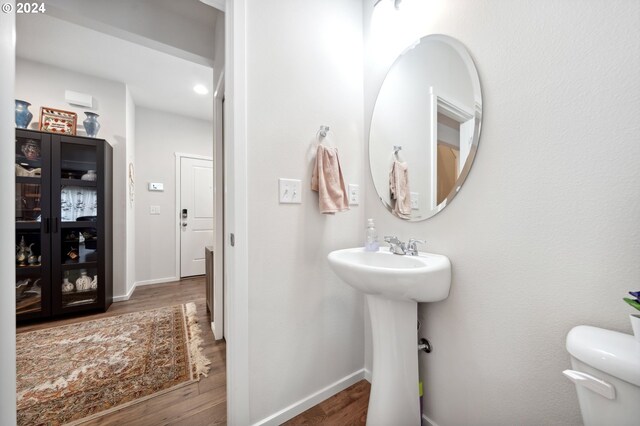 bathroom featuring toilet and hardwood / wood-style floors