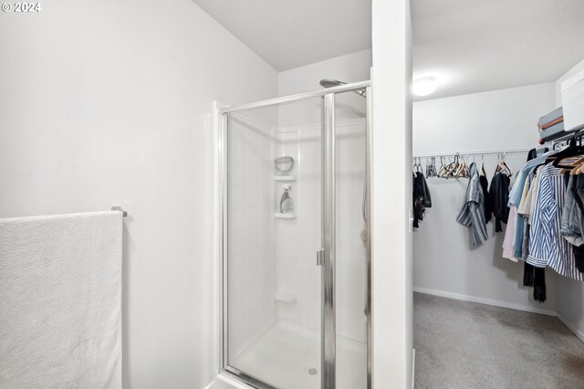 bathroom with a shower with door