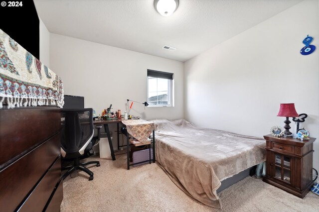 bedroom featuring light carpet