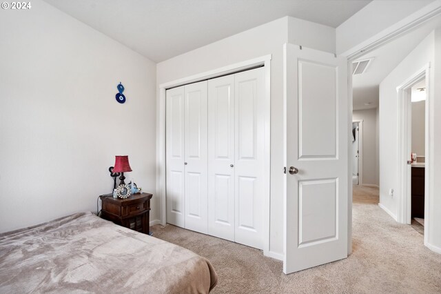 carpeted bedroom featuring a closet