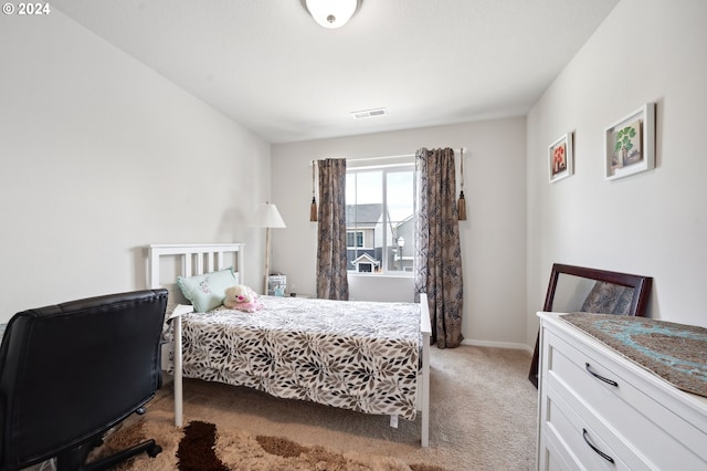 bedroom featuring light carpet