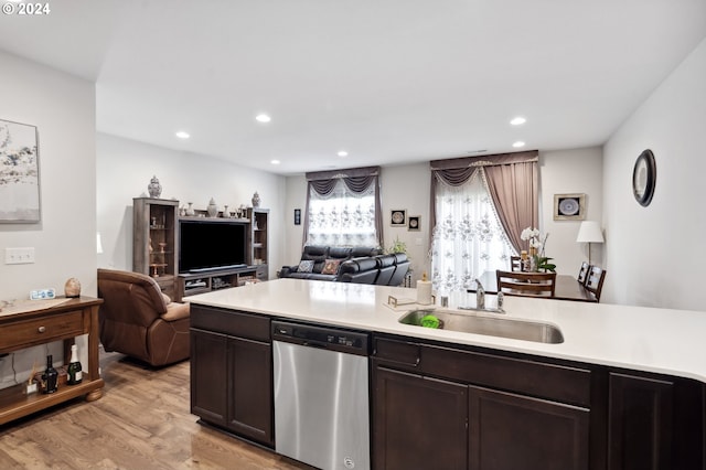 kitchen with light wood-type flooring, sink, dark brown cabinetry, and stainless steel dishwasher