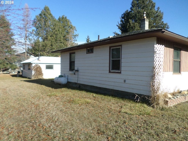 back of house with a lawn