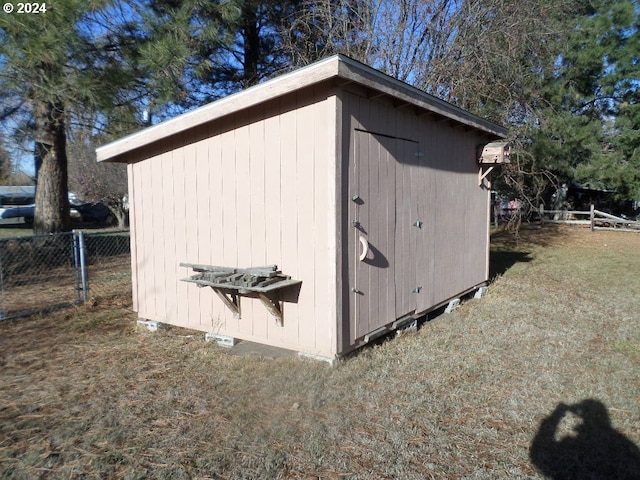 view of outdoor structure featuring a lawn