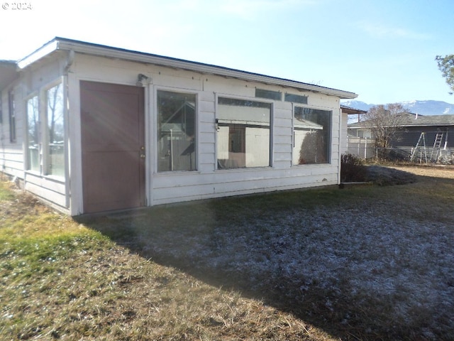 view of side of property with a mountain view