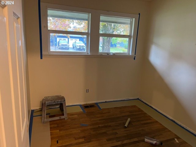 spare room with hardwood / wood-style floors