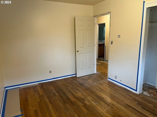 unfurnished bedroom featuring dark wood-type flooring