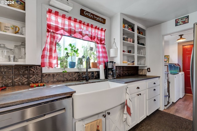 kitchen with white cabinets, sink, dishwasher, separate washer and dryer, and hardwood / wood-style floors