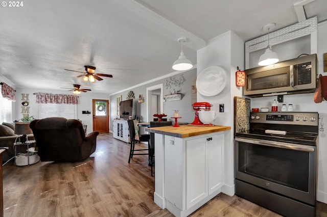 kitchen with white cabinetry, butcher block countertops, pendant lighting, stainless steel appliances, and ceiling fan