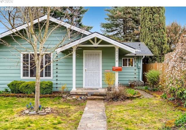 bungalow-style home featuring a front yard