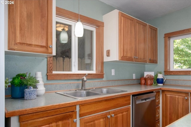 kitchen with pendant lighting, dishwasher, and sink