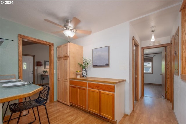 kitchen with ceiling fan and light hardwood / wood-style flooring