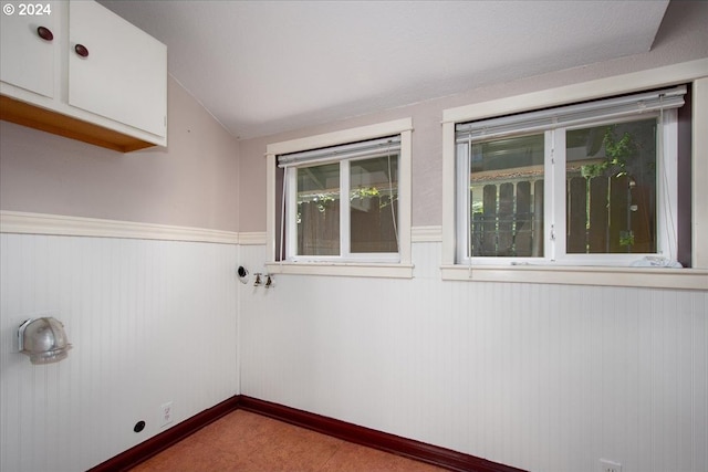 spare room featuring lofted ceiling