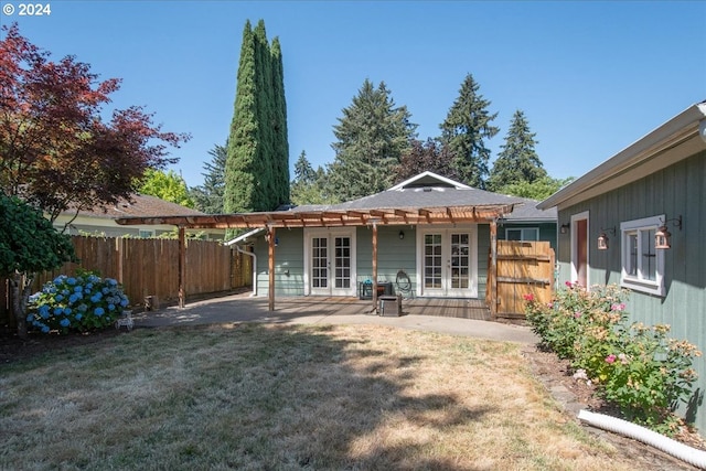 rear view of property featuring a yard and a patio