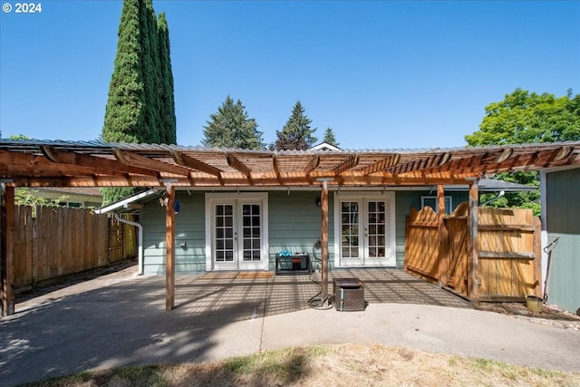 rear view of property with french doors and a patio