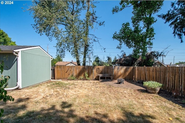 view of yard with an outdoor fire pit