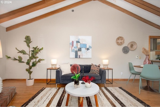 living room featuring light wood-type flooring, beam ceiling, and high vaulted ceiling