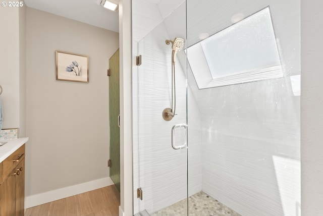 full bath with a shower stall, baseboards, and vanity