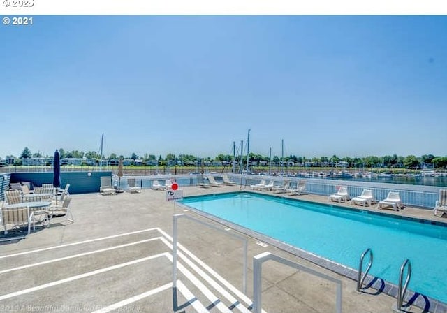 community pool with a patio area