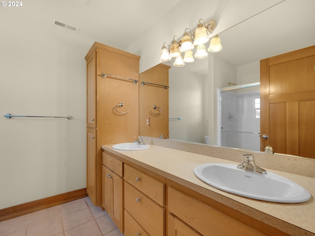 bathroom featuring toilet, dual bowl vanity, and tile flooring