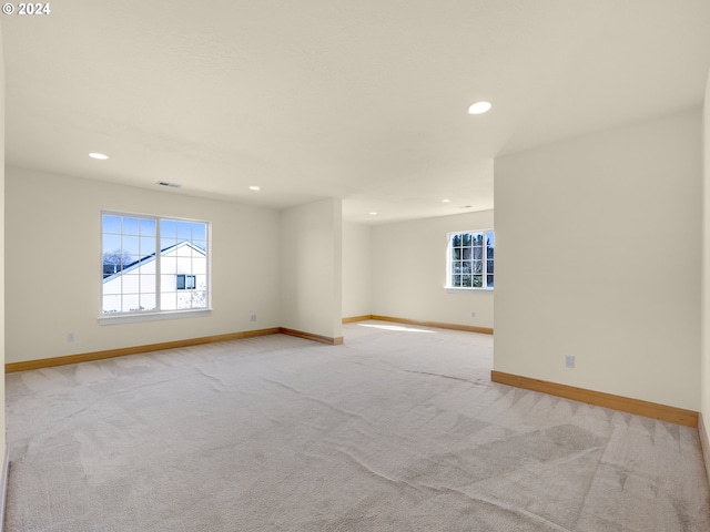 unfurnished room featuring light carpet