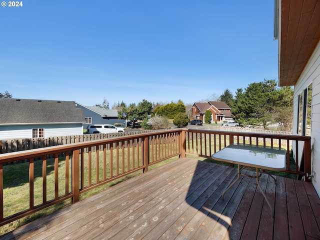 wooden deck with a lawn