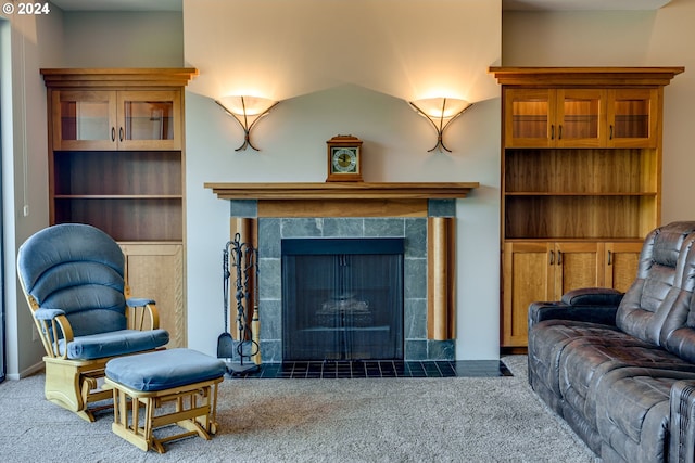 living room with a fireplace and carpet