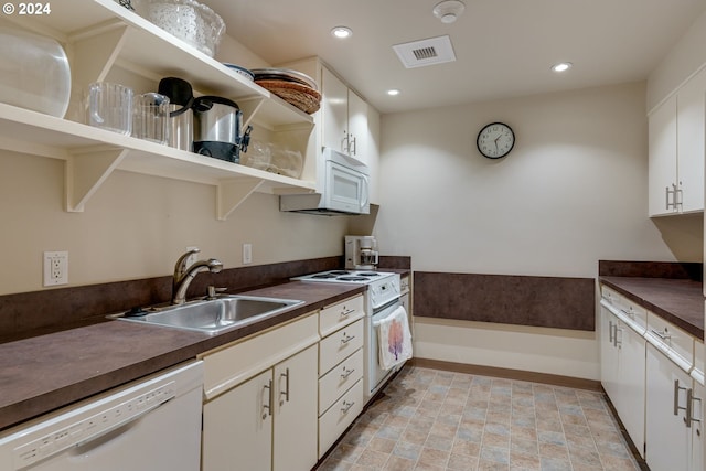 kitchen with sink, white appliances, white cabinetry, and light tile floors